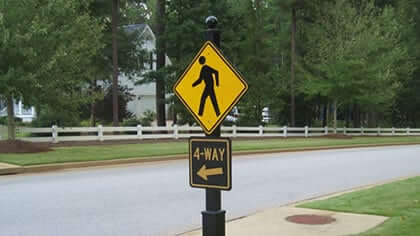 AOD pedestrian crossing and 4 way signs on a decorative post